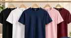 All five Nasheyy t-shirts on hangers - black, white, navy blue, pink and maroon
